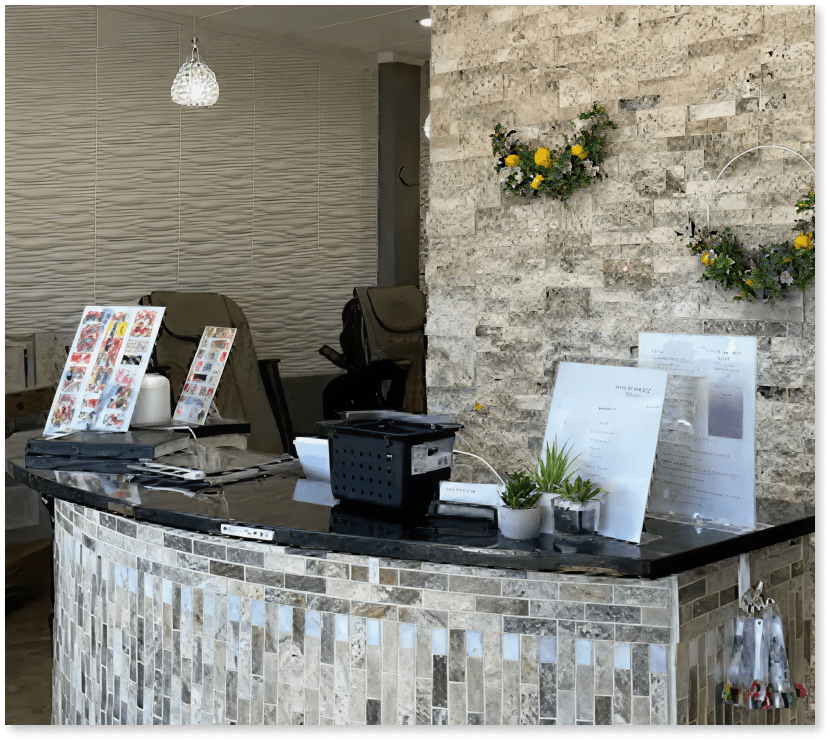 Reception desk and interior of a modern nail and beauty salon.