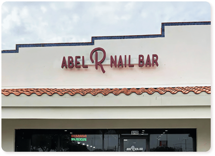 Exterior building sign that reads "ABEL R NAIL BAR".