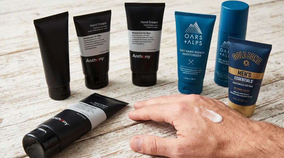 Man applying hand moisturizer after nail care routine