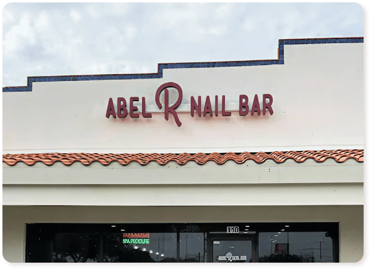Exterior building sign that reads "ABEL R NAIL BAR".
